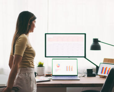 Woman stretching while working at home during pandemic lockdown