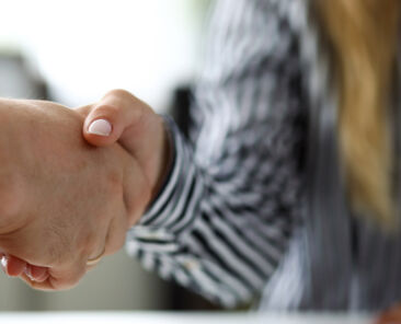 Man and woman shaking hands after productive deliberations closeup