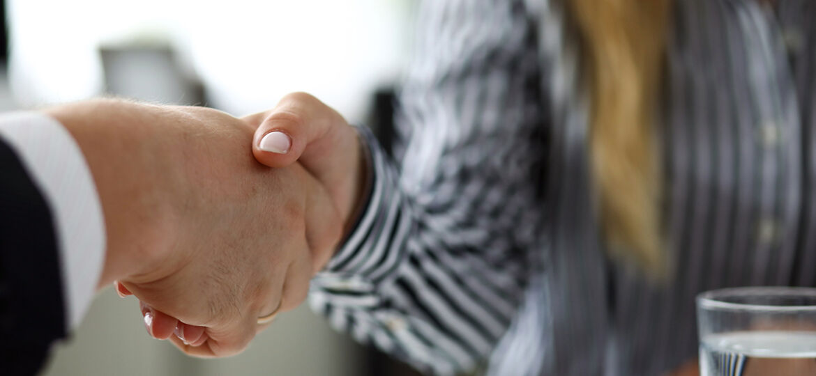 Man and woman shaking hands after productive deliberations