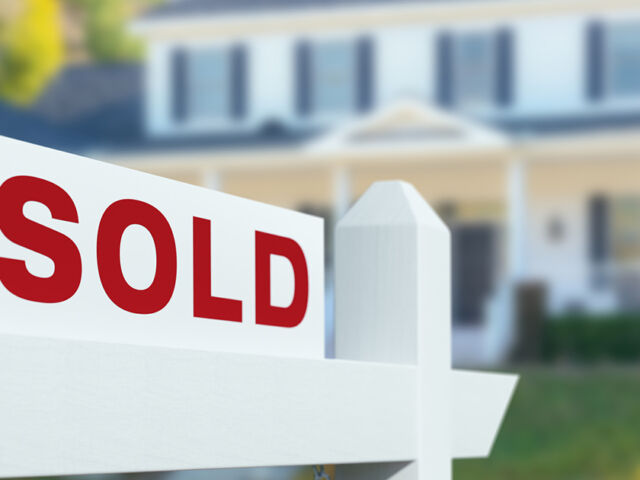 Sold For Sale Real Estate Sign in Front of New House.